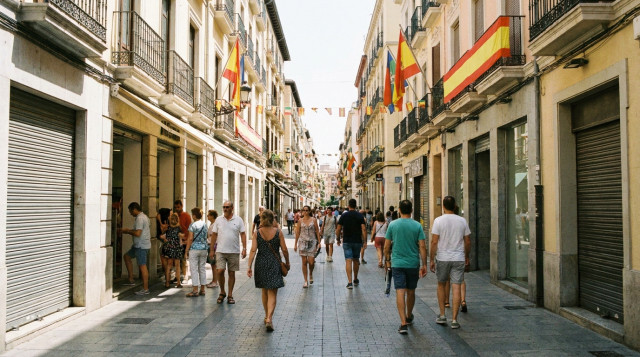 Vista exterior de un eje comercial céntrico en España durante el festivo del 15 de agosto con comercios de diferente tipología