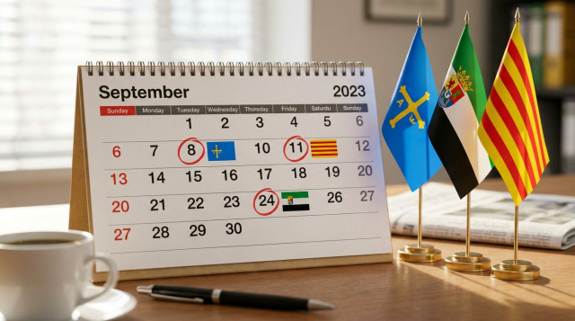 calendario de mesa abierto en el mes de septiembre con los festivos autonómicos destacados junto a banderas de comunidades autónomas