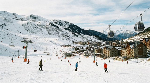 Vista panorámica de pistas de esquí en los Pirineos con esquiadores y remontes preparados al inicio de la temporada de invierno